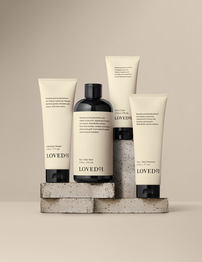 Product collection image with a tan background. The image shows the Exfoliating Cleanser, Shave Cream, Face+Body Wash and Face+Body Moisturizer.