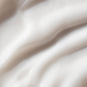 Close-up image of face and body wash texture. The texture appears smooth and rich, with a glossy sheen reflecting light.