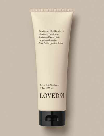 Product image with a tan background. The image shows the Face + Body Moisturizer..